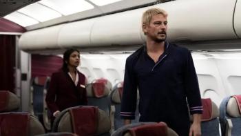 Fight or Flight movie: Josh Hartnett, bruised and intense, walking in front of Charithra Chandran in an airplane cabin