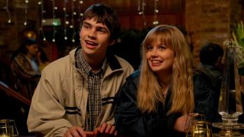 Finding Emily: A young man and woman smiling in a cozy, warmly-lit restaurant