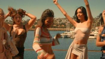 Find Your Friends: Women dancing joyfully on a boat with a marina in the background.