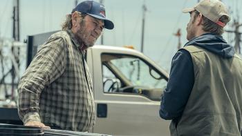 Finestkind Movie: Tommy Lee Jones, wearing a ball cap and a plaid shirt, leans against a car while speaking to his son (Ben Foster) at a marina