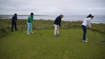 Finnegan’s Foursome movie: the Finnegan family lines up together in a line for a tee shot