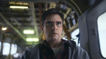 Flight Risk movie: Topher Grace wears glasses and a hoodie inside a small cargo plane