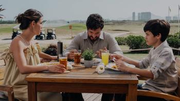 Flywheel: Ignition of the Soul movie: Mario Bregeira sits at the dinner table with Guilherme Tavares and Perola Faria