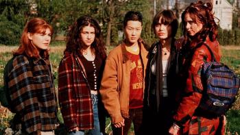 Foxfire: Five teenage girls stand in a row outside looking at something out of shot with serious expressions on their faces