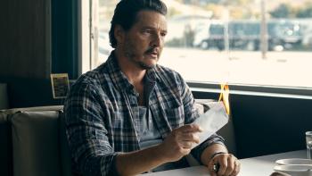 Freaky Tales Movie: In a diner booth, Clint (Pedro Pascal) holds a flaming envelope