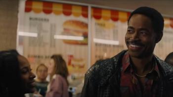 Freaky Tales Movie: NBA star Sleepy Floyd (Jay Ellis) smiles while swarmed by fans at a burger stand