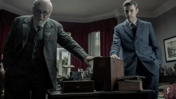 Freud's Last Session Movie: Anthony Hopkins and Matthew Goode stand near a desk in a study
