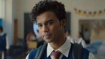 Friday Night Plan scene 3:  a young Indian man looks pensive