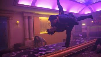 The Furious Movie: In a nightclub illuminated by purple light, Navin (Joe Taslim) flips an opponent