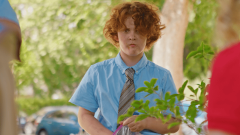 The Furry Fortune: a boy wearing a shirt and tie with a confused look on his face