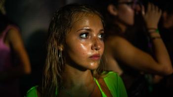 How to Have Sex: A White teenage girl wearing a bright green outfit looks concerned on a night out.