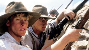 Gallipoli movie: Mark Lee stands in a trench at Gallipoli with his fellow soldiers, armed with a rifle