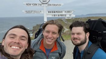 George Ezra -- End to End: George Ezra and two friends take selfie on coast with sign post behind them