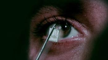 Ghost in the Machine movie: Close-up of an eye with a microchip reflected on it.