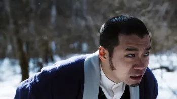 Golden Kamuy movie: Japanese man in short hair and robe stands worried in the forest and snow