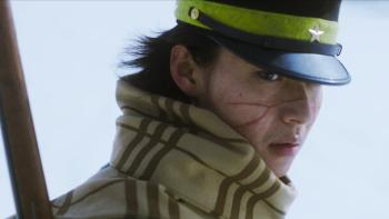 Golden Kamuy movie: Japanese soldier with scarf, soldier cap, gun on back, and face scars looks serious
