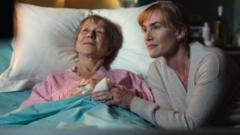 Goodbye June movie: Helen Mirren lays in a hospital bed as Kate Winslet leans forward and holds her hand