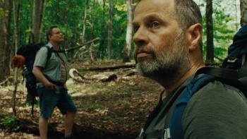 Good One Movie: Matt (Danny McCarthy), in the distance, and Chris (James Le Gros), close-up, contemplate the woods