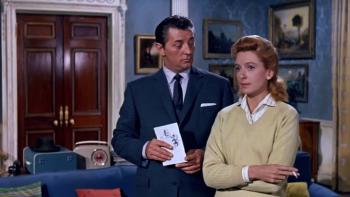 The Grass Is Greener: Robert Mitchum and Deborah Kerr stand in a living space together