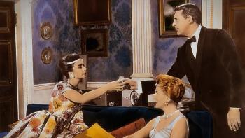 The Grass Is Greener: Jean Simmons leans across a couch to take a drink from Carry Grant, while Deborah Kerr sits next to her