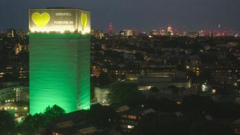Grenfell—Uncovered: Grenfell Tower is lit up in yellow and green with "Grenfell forever in our hearts" written on the top