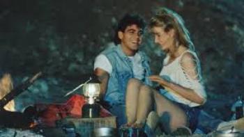Grizzly II: George Clooney and woman snuggle together outside