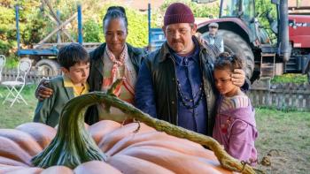 Grow movie: Dominic McLaughlin, Golda Rosheuvel, Nick Frost, and Priya-Rose Brookwell stand looking at a giant pumpkin