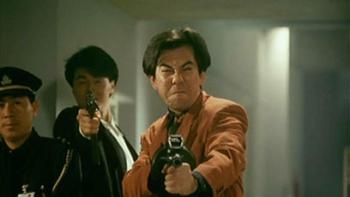 Hard Boiled: Anthony Wong points a machine gun with two others behind him, one pointing a pistol