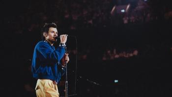 Harry Styles — One Night in Manchester: Harry Styles sings into a microphone onstage