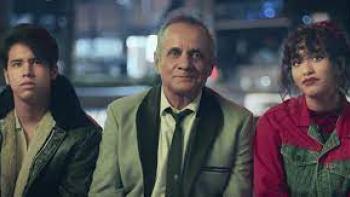 Have a Nice Day: Mexican man in white suit center is flanked by Mexican teenage boy in black leather jacket on left and Mexican teenage girl in red jean jacket on right