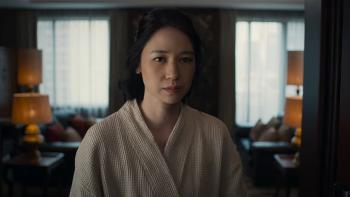 Heartbreak Motel movie: Indonesian woman in white robe center stands in living room