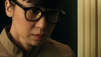 Heartbreak Motel movie: Indonesian woman in glasses looks down pensively next to yellow door frame