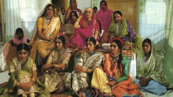 Heat and Dust: A group of women sit together wearing saris