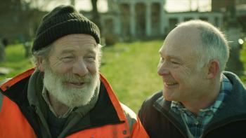 Hector: Two older White men smiling together