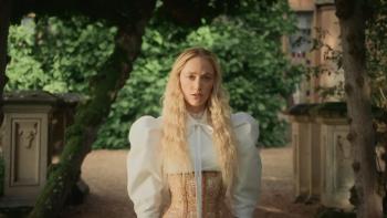 100 Nights of Hero: A young White woman stands in a white outfit in the grounds of a stately home