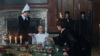 100 Nights of Hero: A young White woman sits at an imposing dinner table as her maid and a male houseguest offer her water from either side