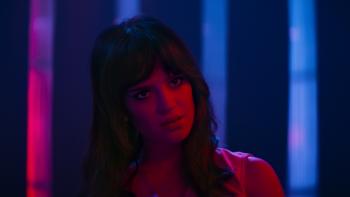 Her Private Hell Movie: Elle, bathed in red light, appears perturbed about something