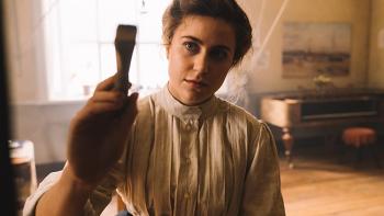 Hilma Movie: Tora Hallström holds up a paintbrush