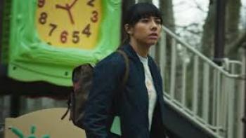 Hive Movie: Xochitl Gomez with backpack walks past green clock