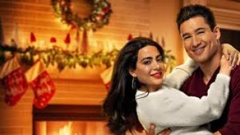 Holiday in Santa Fe: Mario Lopez embraces Emeraude Toubia by the fireplace