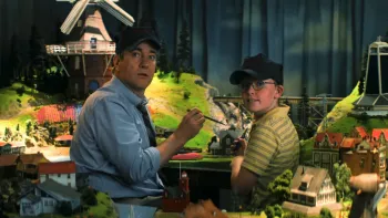 Holland: Father and son work on a model town.