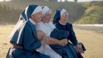 Holy Days: Three nuns sit together smiling at the beach