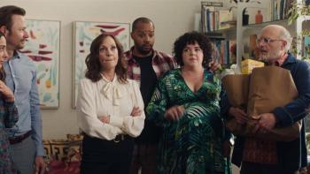 Home Delivery movie: Family members stand with a pregnant woman (Melanie Field), reacting to something that was said