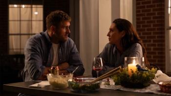 How Hard Can It Be movie: Jack Kesy and Anna Schafer look at each other at the dinner table outside at night