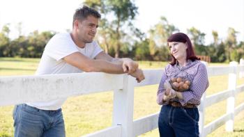 How Hard Can It Be movie: Jack Kesy leans on a fence as he talks to Kat Flannery holding a basket of eggs