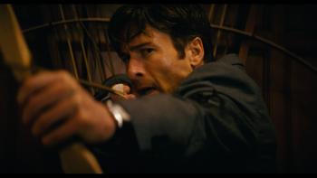 How to Make a Killing movie: Glen Powell pulls back on a bow as he prepares to shoot an arrow