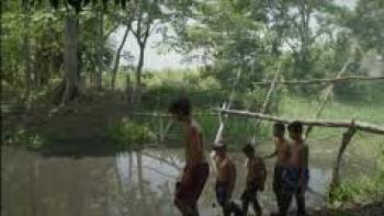 Hurricane Season scene 3:  Boys play by body of water