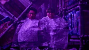 Husbands in Action movie: Gong Myoung and Jin Seon-kyung sit huddle together in a freezer, covered in paper