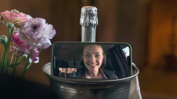 I Don't Understand You movie: Amanda Seyfriend beams on the screen of an iPhone screen that's sitting on a champagne bucket