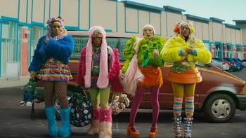 I Love Boosters movie: Four women in colorful, fluffy outfits stand in front of a car